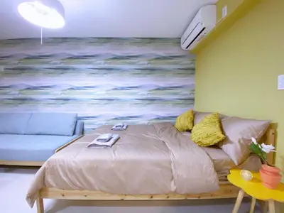 a bed in a room with a painting on the wall at nestay apartment tokyo ginza in Tokyo