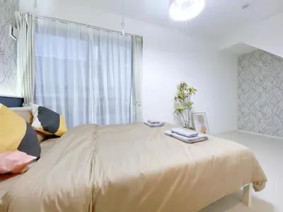 a bedroom with a large bed and a window at nestay apartment tokyo ginza in Tokyo