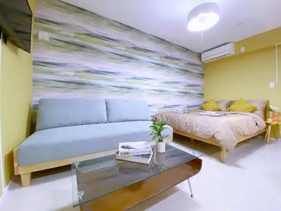 a bedroom with a bed and a painting on the wall at nestay apartment tokyo ginza in Tokyo