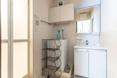 a kitchen with a white refrigerator and a sink at Shibuya \u6e0b\u8c37 \u4e0b\u5317\u6ca2\u30a8\u30ea\u30a2 \u96fb\u52d5\u30ad\u30c3\u30af\u30dc\u30fc\u30c9LUUP\u6577\u5730\u5185 \u99c5\u5f92\u6b693\u5206 in Tokyo