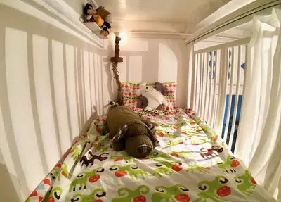 a teddy bear laying on a bed in a bedroom at TOKYO Ebisu! 2adults & 2kids Max4ppl FamilyOK! in Tokyo