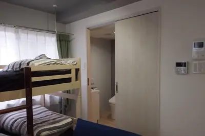 a bedroom with a bunk bed and a bathroom at Belle harmonie togoshi203 in Tokyo