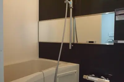 a bathroom with a bath tub and a sink at Belle harmonie togoshi203 in Tokyo