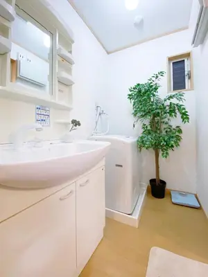 a bathroom with a sink and a potted plant at nestay villa tokyo takanawa in Tokyo