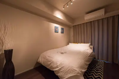 a bedroom with a white bed with two glasses on it at HIZ HOTEL - Vacation STAY 08966v in Tokyo
