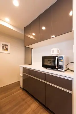 a kitchen with black cabinets and a microwave at HIZ HOTEL - Vacation STAY 08955v in Tokyo
