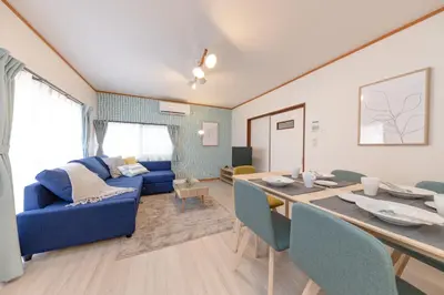 a living room with a blue couch and a table at Serendipity Koiwa - Vacation STAY 11031v in Tokyo