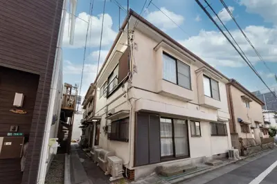 a white building on a street next to a building at Serendipity Koiwa - Vacation STAY 11031v in Tokyo