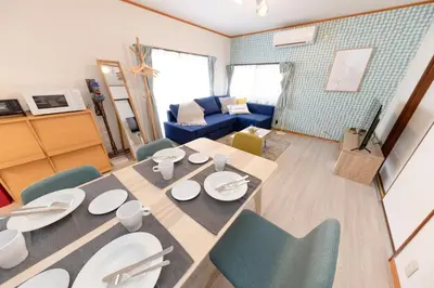 a living room with a dining room table and chairs at Serendipity Koiwa - Vacation STAY 11031v in Tokyo