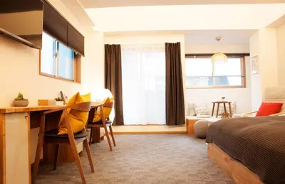 a bedroom with a desk and a bed and a desk at Monoka Hotel Ginza in Tokyo