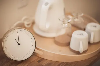 a clock sitting on top of a table with some items at Monoka Hotel Ginza in Tokyo