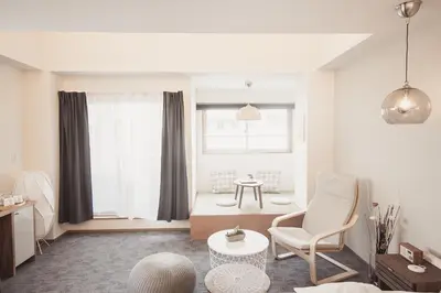 a living room with a couch and a chair at Monoka Hotel Ginza in Tokyo