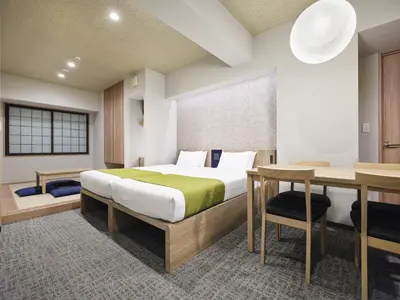 a hotel room with a bed and a desk at MONday Apart Premium UENO in Tokyo