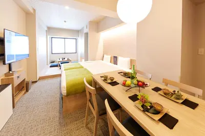 a room with a bed and a table with fruits on it at MONday Apart Premium UENO in Tokyo