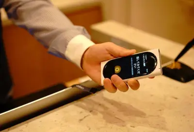 a person holding a remote control in their hand at MONday Apart Premium UENO in Tokyo