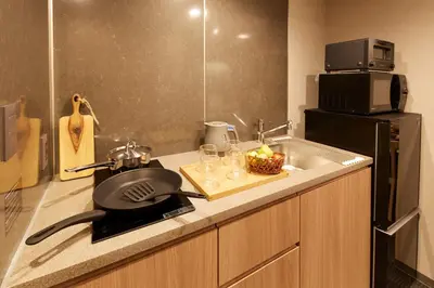 a kitchen with a pan on a counter next to a sink at MONday Apart Premium Ginza Shintomicho in Tokyo