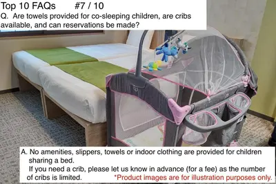 a baby crib in a room with a bed and a flyer with a picture at MONday Apart Premium Ginza Shintomicho in Tokyo