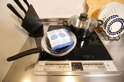 a stove top with a pot on top of it at Uhome Suido Apartment SD in Tokyo