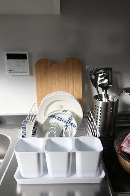 a pile of plates and bowls on a kitchen counter at Uhome Suido Apartment SD in Tokyo