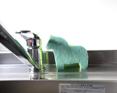 a green toy horse sitting on top of a sink at Uhome Suido Apartment SD in Tokyo