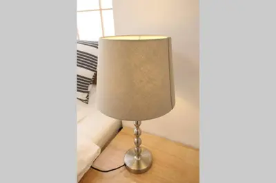 a lamp sitting on a floor in a room at Uhome Suido Apartment SD in Tokyo
