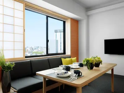 a living room with a table and a couch at MIMARU Tokyo Asakusa Station in Tokyo
