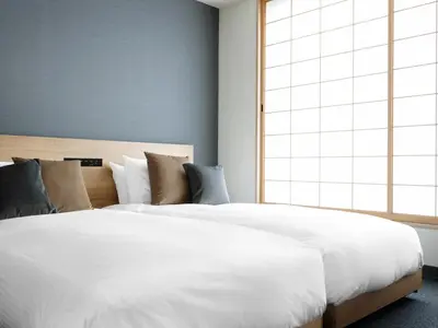 a bedroom with a large white bed and a window at MIMARU Tokyo Asakusa Station in Tokyo