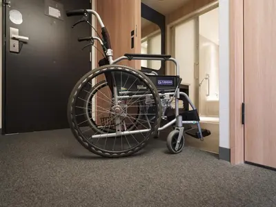 a wheelchair in a hallway next to a door at MIMARU Tokyo Asakusa Station in Tokyo