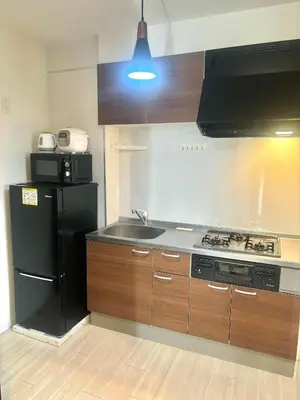 a kitchen with a black refrigerator and a sink at \u6771\u4eac \u8db3\u7acb\u533a\u9752\u4e95 Tokyo Adachiku Aoi in Tokyo