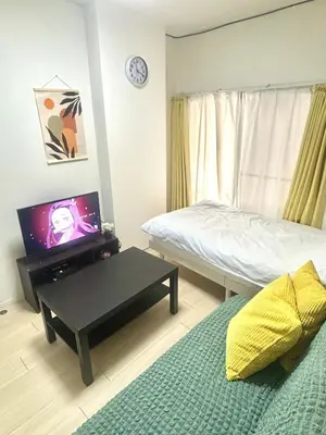 a bedroom with a bed and a table with a tv at \u6771\u4eac \u8db3\u7acb\u533a\u9752\u4e95 Tokyo Adachiku Aoi in Tokyo