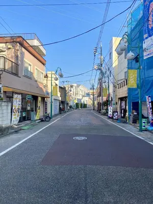 an empty street in a city with buildings at \u6771\u4eac \u8db3\u7acb\u533a\u9752\u4e95 Tokyo Adachiku Aoi in Tokyo