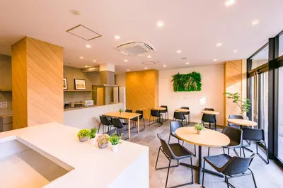 a restaurant with tables and chairs in a building at &AND HOSTEL ASAKUSA KAPPABASHI in Tokyo