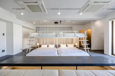 a bedroom with two bunk beds in a room at Cocts Akihabara in Tokyo