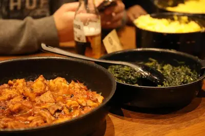 two pans of food sitting on a table at Cocts Akihabara in Tokyo