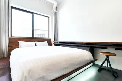 a bedroom with a white bed and a window at Cocts Akihabara in Tokyo