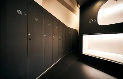 a locker room with black cabinets and a light at Cocts Akihabara in Tokyo
