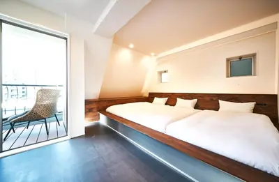 a bedroom with a bed and a large window at Cocts Akihabara in Tokyo