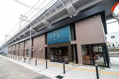 a building with a sign on the side of it at Wise Owl Hostels River Tokyo in Tokyo