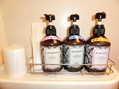 three bottles of soap and toiletries on a shelf at Hotel Suntargas Otsuka - Vacation STAY 08516v in Tokyo