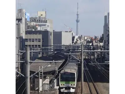 a train is on the tracks in a city at Hotel Suntargas Otsuka - Vacation STAY 08520v in Tokyo
