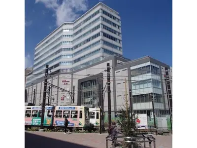 a large building with a bus in front of it at Hotel Suntargas Otsuka - Vacation STAY 08508v in Tokyo