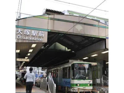 a person walking under an overpass with a train at Hotel Suntargas Otsuka - Vacation STAY 08522v in Tokyo