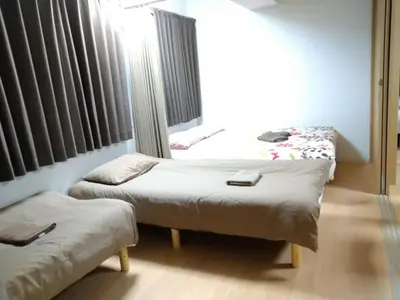 two beds in a room with a window at Isshuku Ryokan Asakusabashi - Vacation STAY 13125v in Tokyo