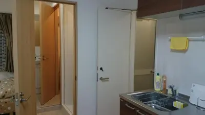 a small kitchen with a sink and a shower at Isshuku Ryokan Asakusabashi - Vacation STAY 13125v in Tokyo