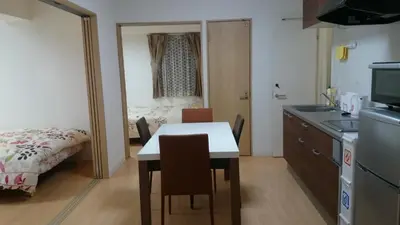 a kitchen with a table and chairs in a room at Isshuku Ryokan Asakusabashi - Vacation STAY 13125v in Tokyo