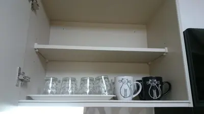 a row of glasses and mugs on a shelf at Isshuku Ryokan Asakusabashi - Vacation STAY 13125v in Tokyo