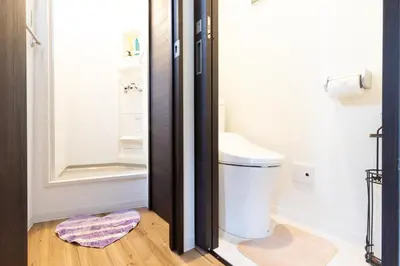 a small bathroom with a toilet and a shower at Peace Inn Skytree Tokyo in Tokyo
