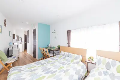 a bedroom with a bed and a living room at Peace Inn Skytree Tokyo in Tokyo