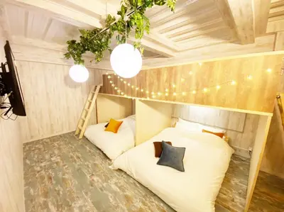a room with two beds in a room with lights at GLAMPEACE\u845b\u98fe\u30fb\u56db\u30c4\u6728 in Tokyo