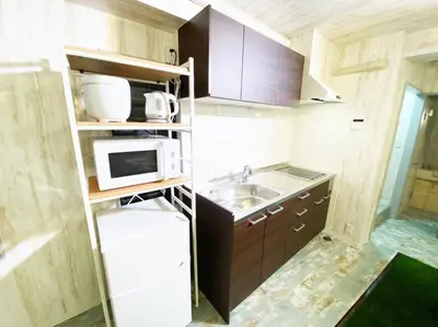 a small kitchen with a sink and a microwave at GLAMPEACE\u845b\u98fe\u30fb\u56db\u30c4\u6728 in Tokyo